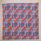 Blue and coral hand block print cotton napkin laid flat, full print visible