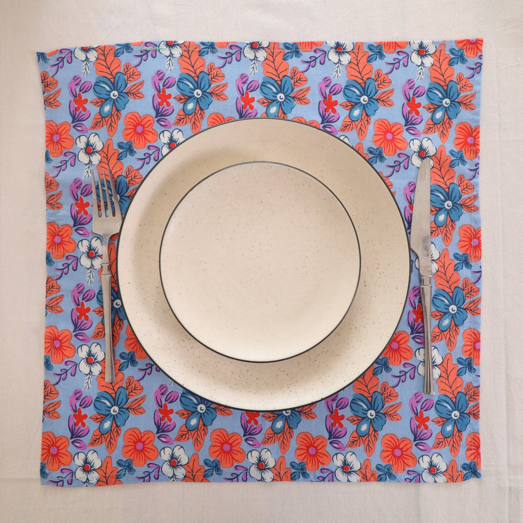 Blue and coral block print napkin set as a place setting with plate and cutlery