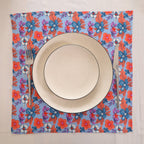 Blue and coral block print napkin set as a place setting with plate and cutlery