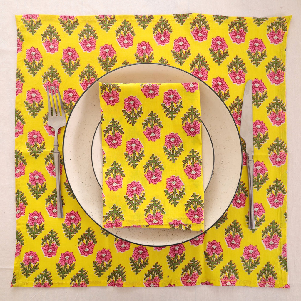Yellow and pink block print napkin set as a place setting with plate and cutlery
