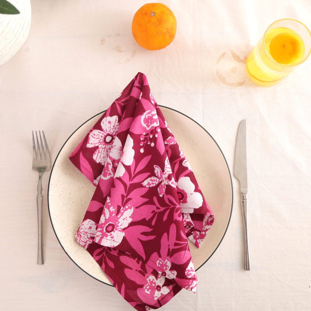 Berry and white block print cotton napkin folded on a dinner plate