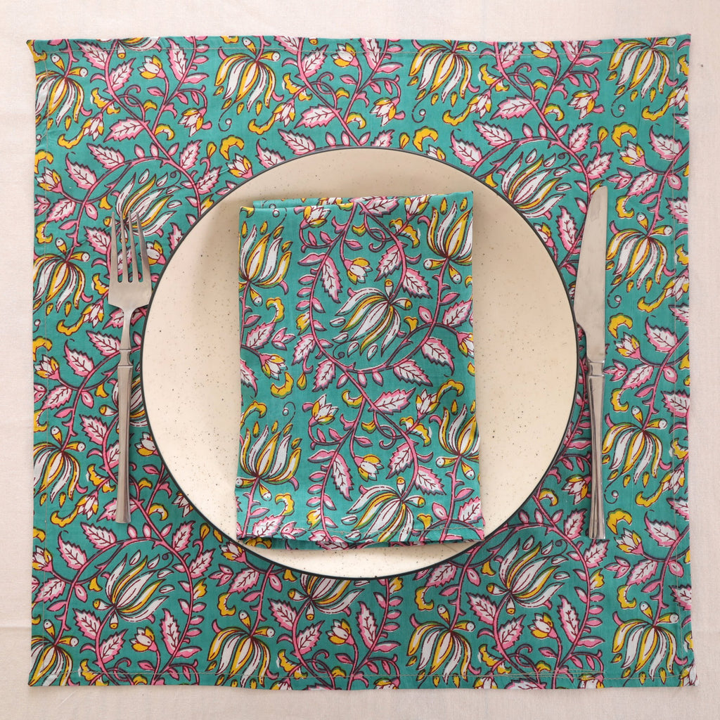 Teal and pink block print napkin set as a place setting with plate and cutlery