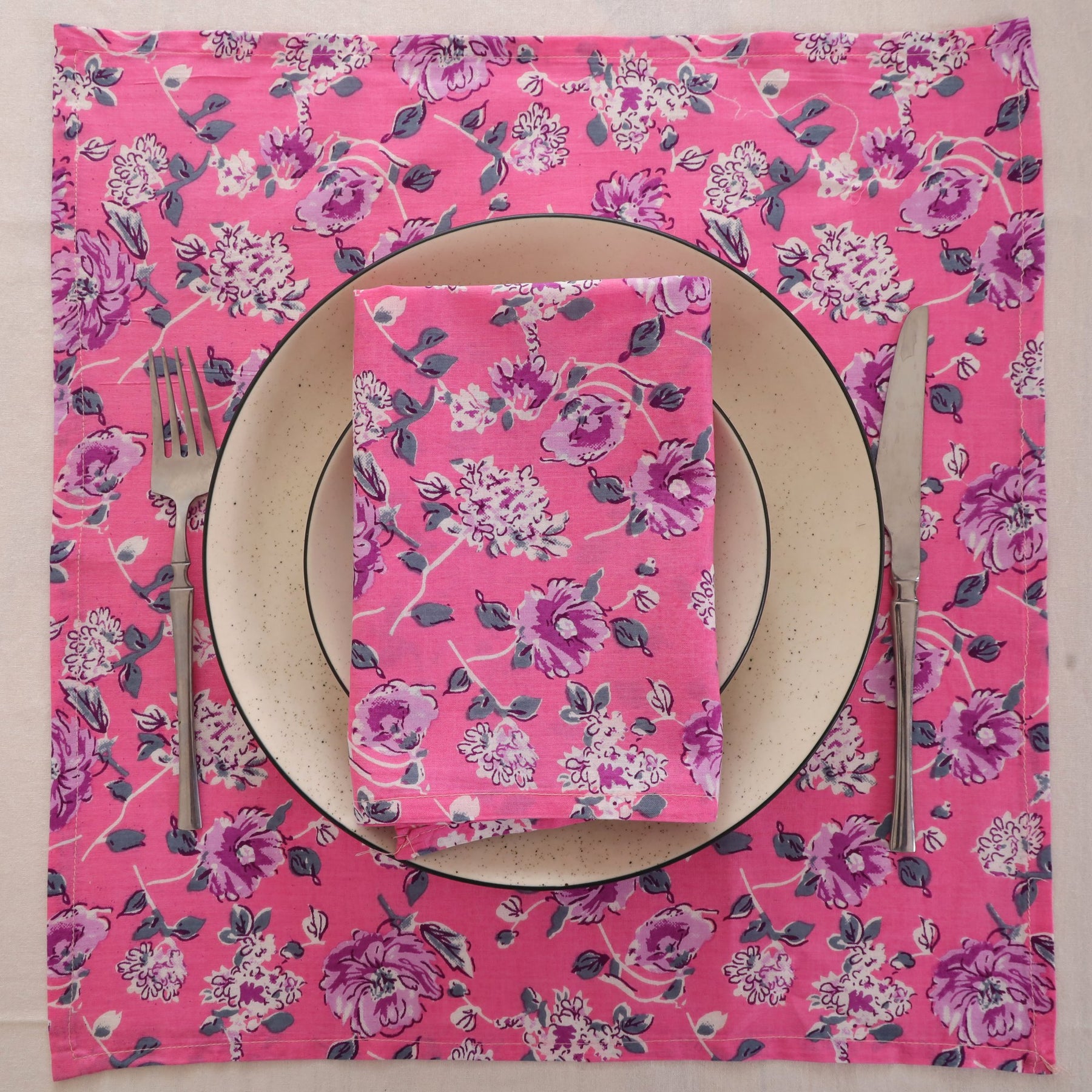 Pink and purple block print napkin set as a place setting with plate and cutlery