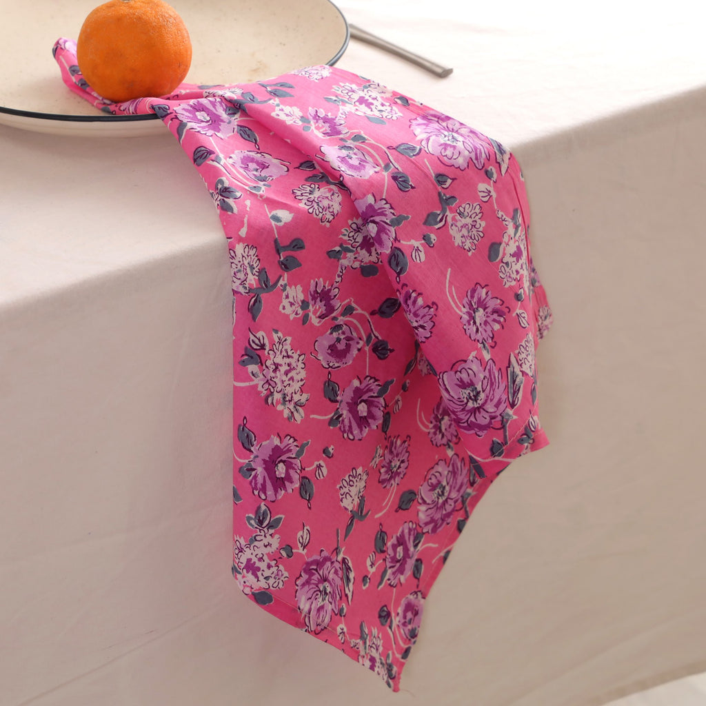 Pink and purple block print napkin draped over the edge of a table