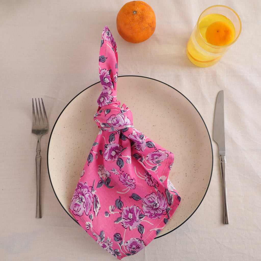 Pink and purple block print cotton napkin knotted on a plate