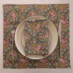 Olive and pink block print napkin set as a place setting with plate and cutlery