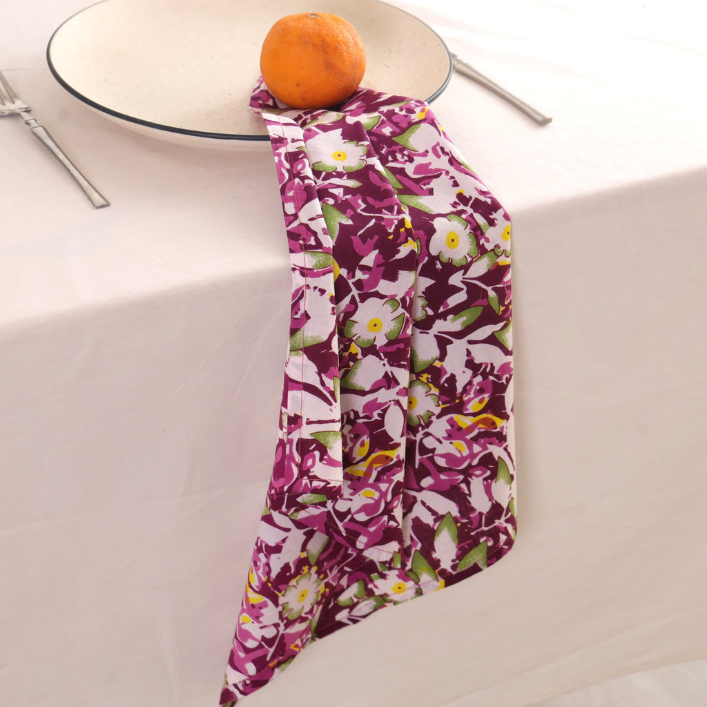 Purple and white block print napkin draped over the edge of a table