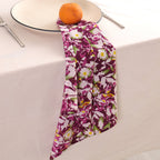 Purple and white block print napkin draped over the edge of a table