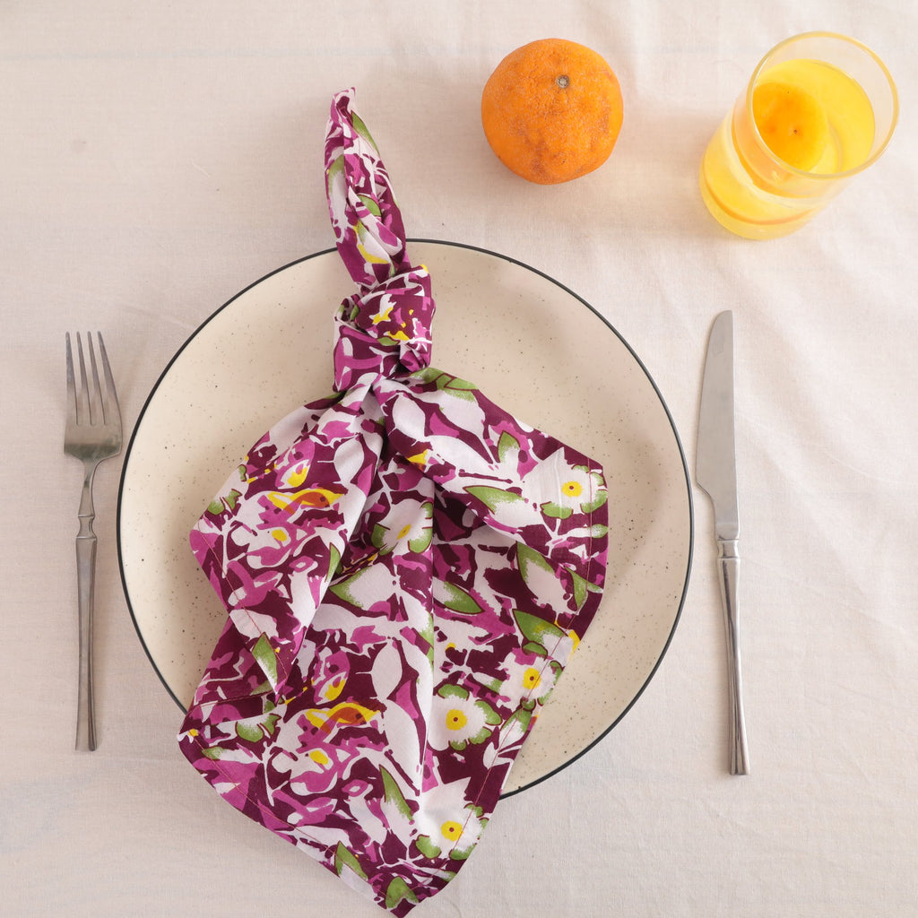 Purple and white block print cotton napkin knotted on a plate