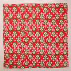 Red and green hand block print cotton napkin laid flat, full print visible