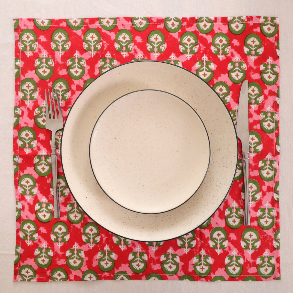 Red and green block print napkin set as a place setting with plate and cutlery