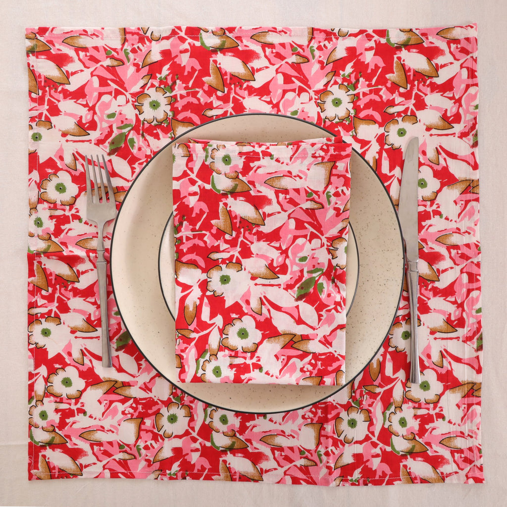 Red and cream block print napkin set as a place setting with plate and cutlery
