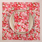 Red and cream block print napkin set as a place setting with plate and cutlery