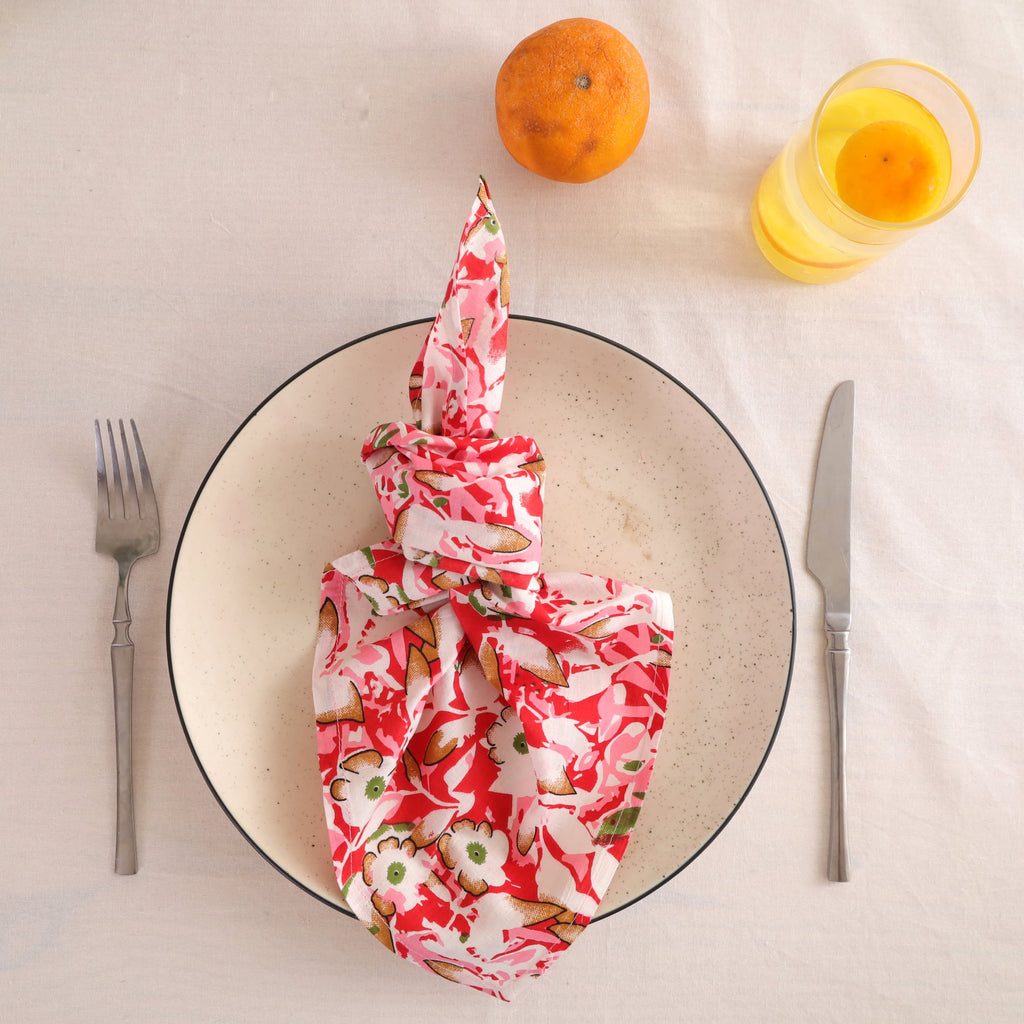 Red and cream block print cotton napkin knotted on a plate