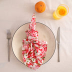 Red and cream block print cotton napkin knotted on a plate