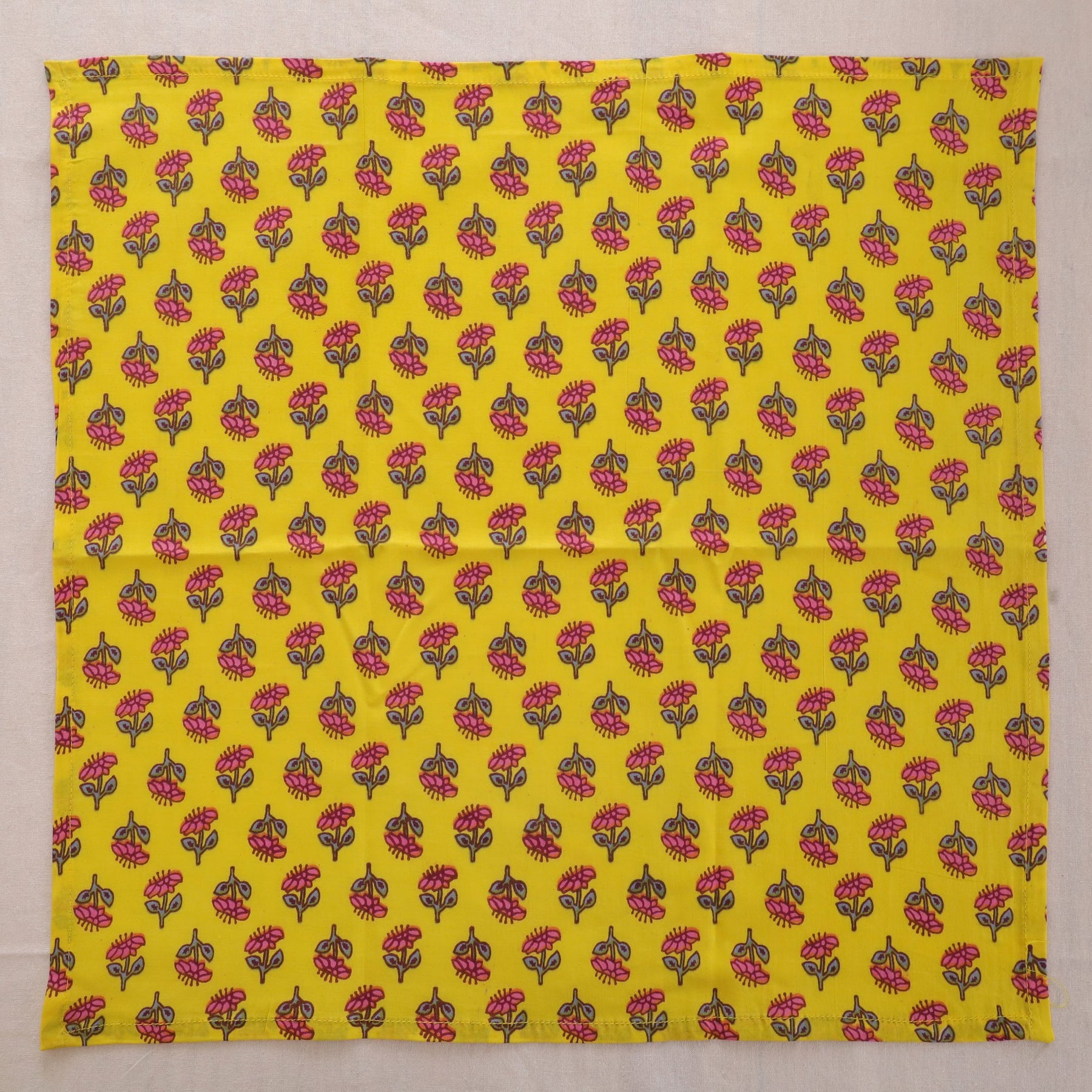 Yellow buti hand block print cotton napkin laid flat, full print visible