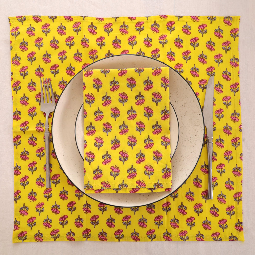 Yellow buti block print napkin set as a place setting with plate and cutlery