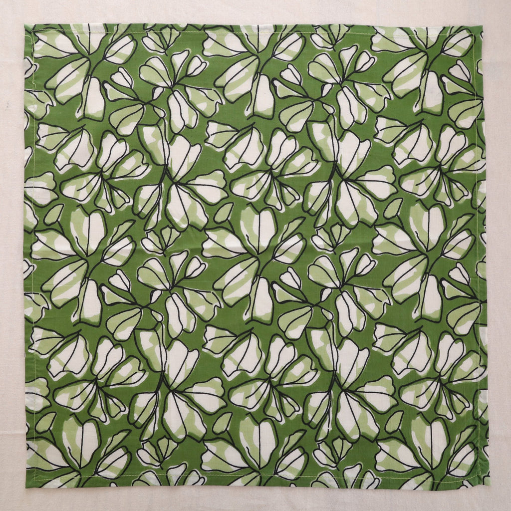 Green and white hand block print cotton napkin laid flat, full print visible