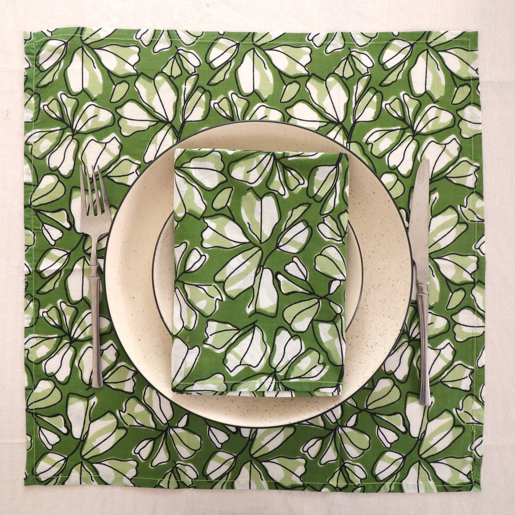 Green and white block print napkin set as a place setting with plate and cutlery