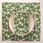 Green and white block print napkin set as a place setting with plate and cutlery