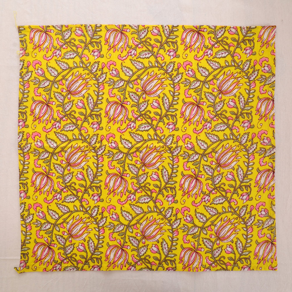 Yellow and pink paisley hand block print cotton napkin laid flat, full print visible