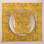 Yellow and pink paisley block print napkin set as a place setting with plate and cutlery