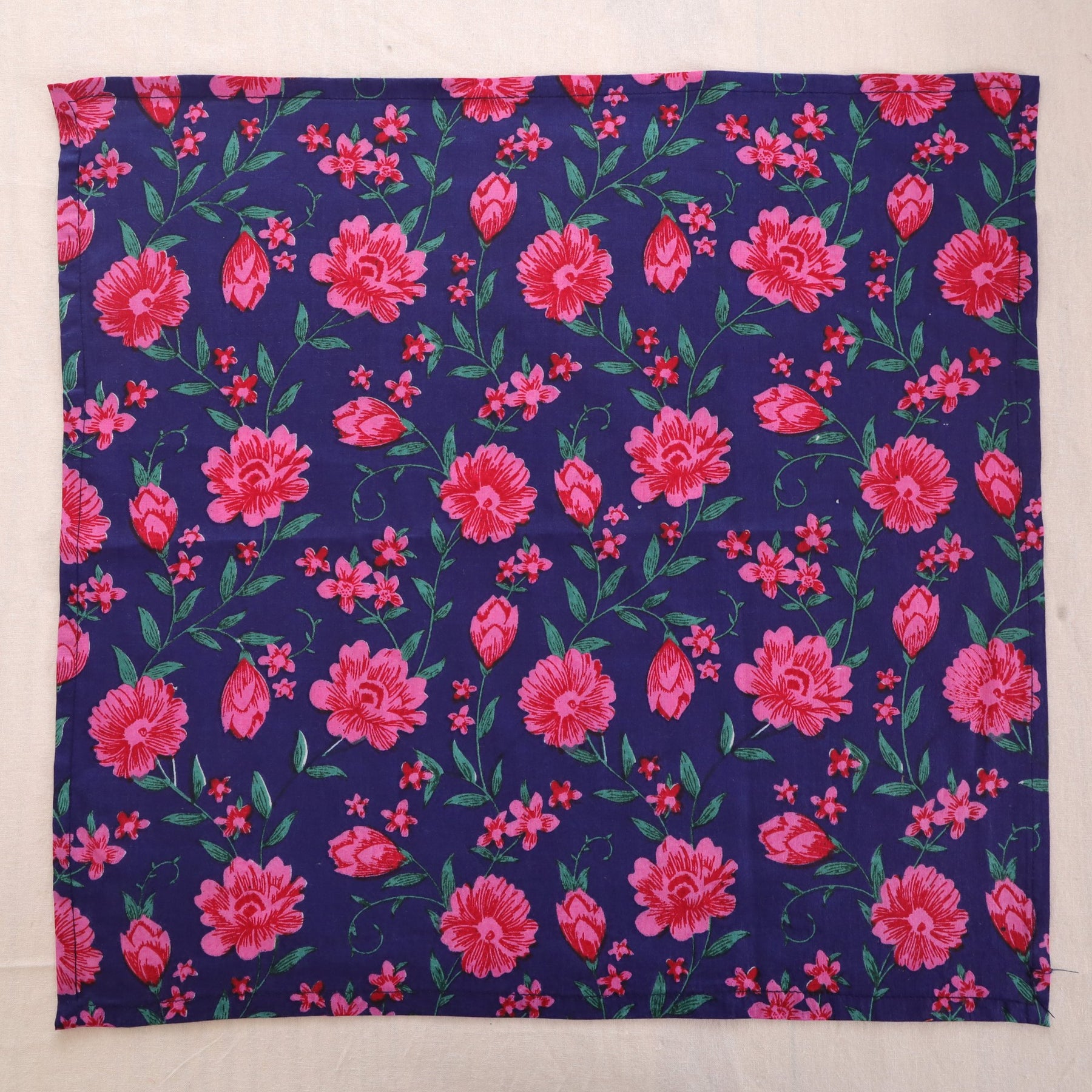 Navy and pink hand block print cotton napkin laid flat, full print visible