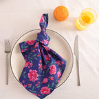 Navy and pink block print cotton napkin knotted on a plate